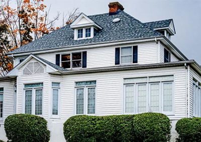 White Roanoke, VA home with black roof installed by Commonwealth Roofing Specialists