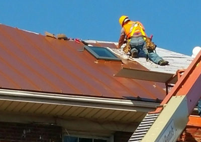 Roofing contractor repairing the roof on a house
