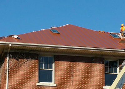 Commonwealth Roofing Specialists repairing a roof